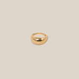 Gold ring on a beige background