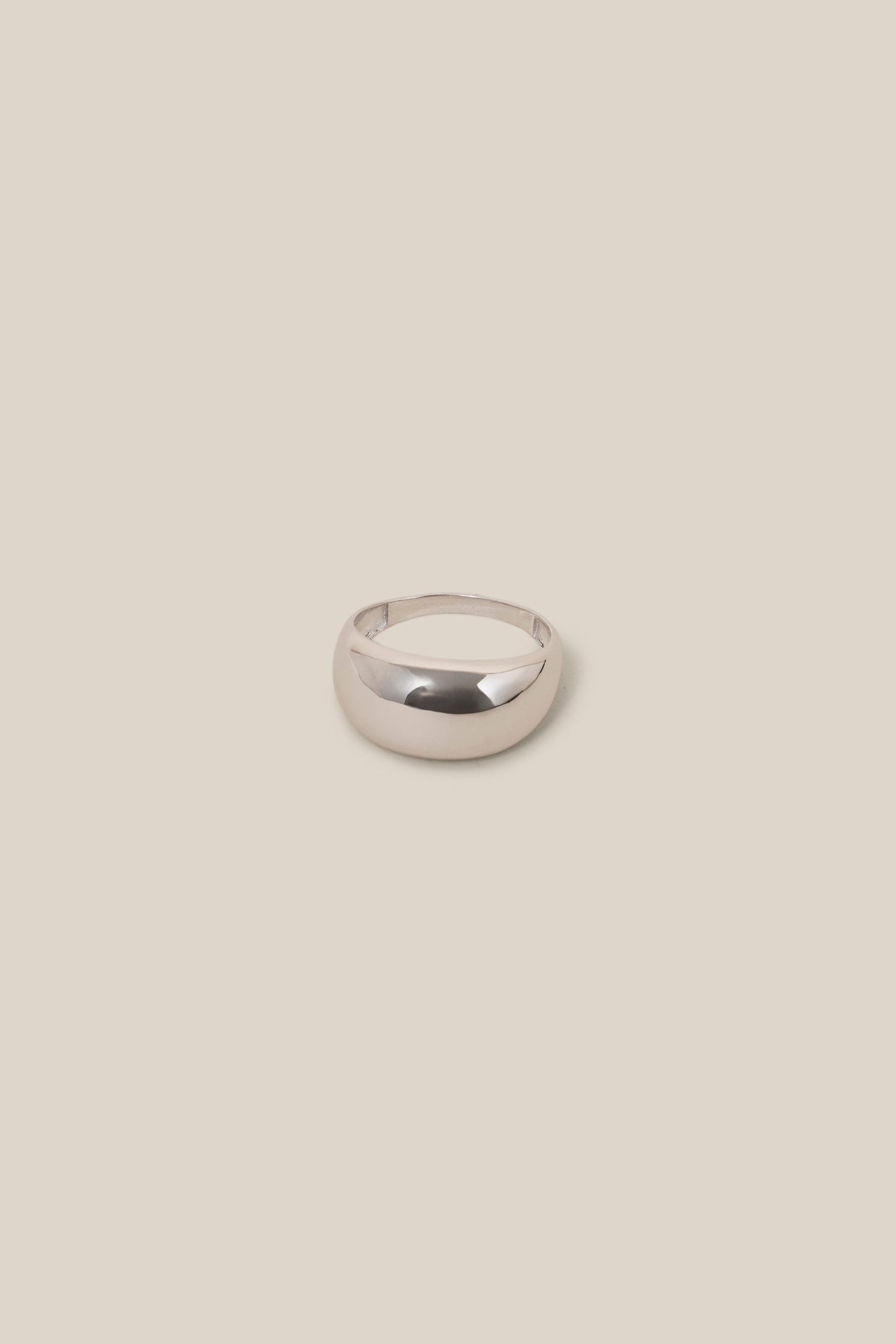 Silver ring on a beige background