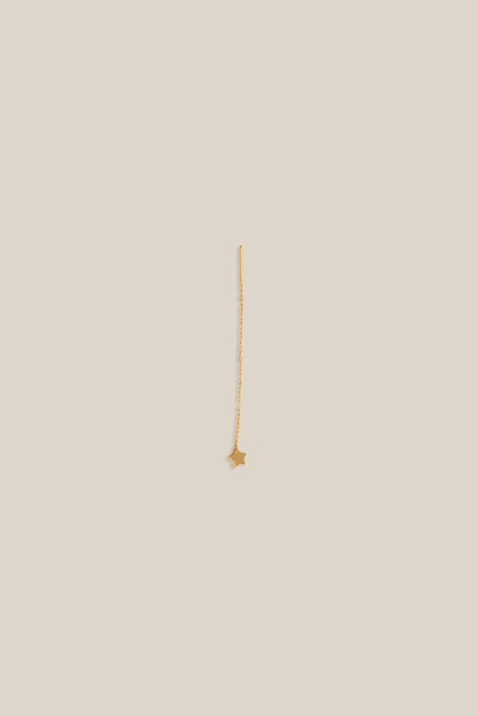 Gold necklace on a beige background