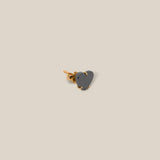 Small heart-shaped object on a beige background