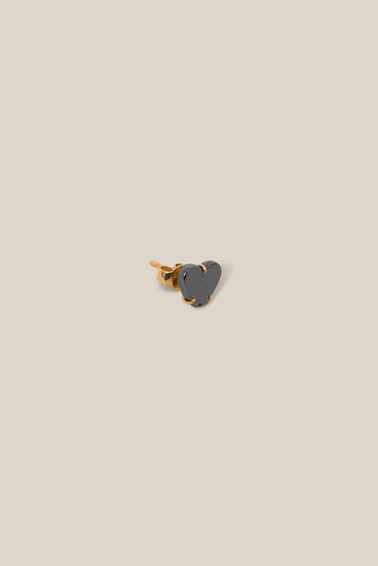 Small heart-shaped object on a beige background