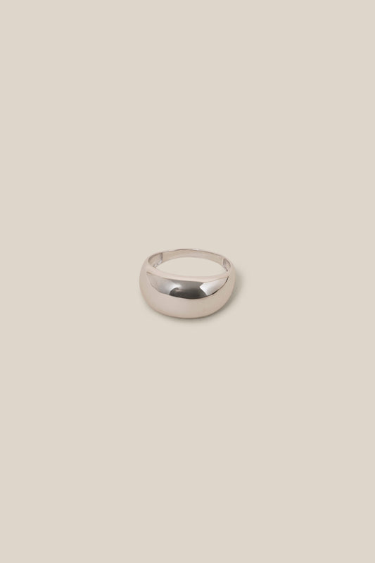 Silver ring on a beige background