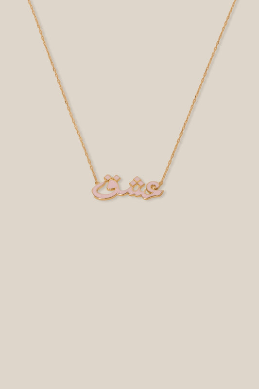 Gold necklace with a bow-shaped pendant on a beige background